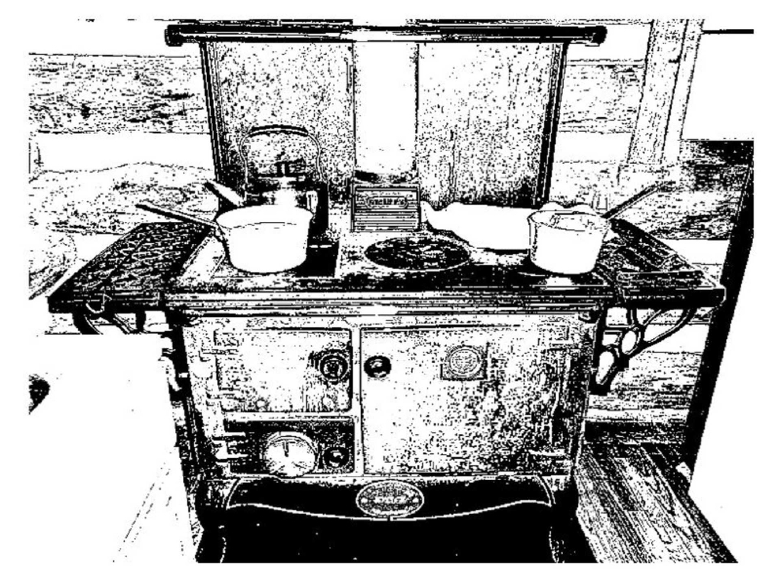old style farmhouse stove with tea kettle and pots in grainy high contrast black and white