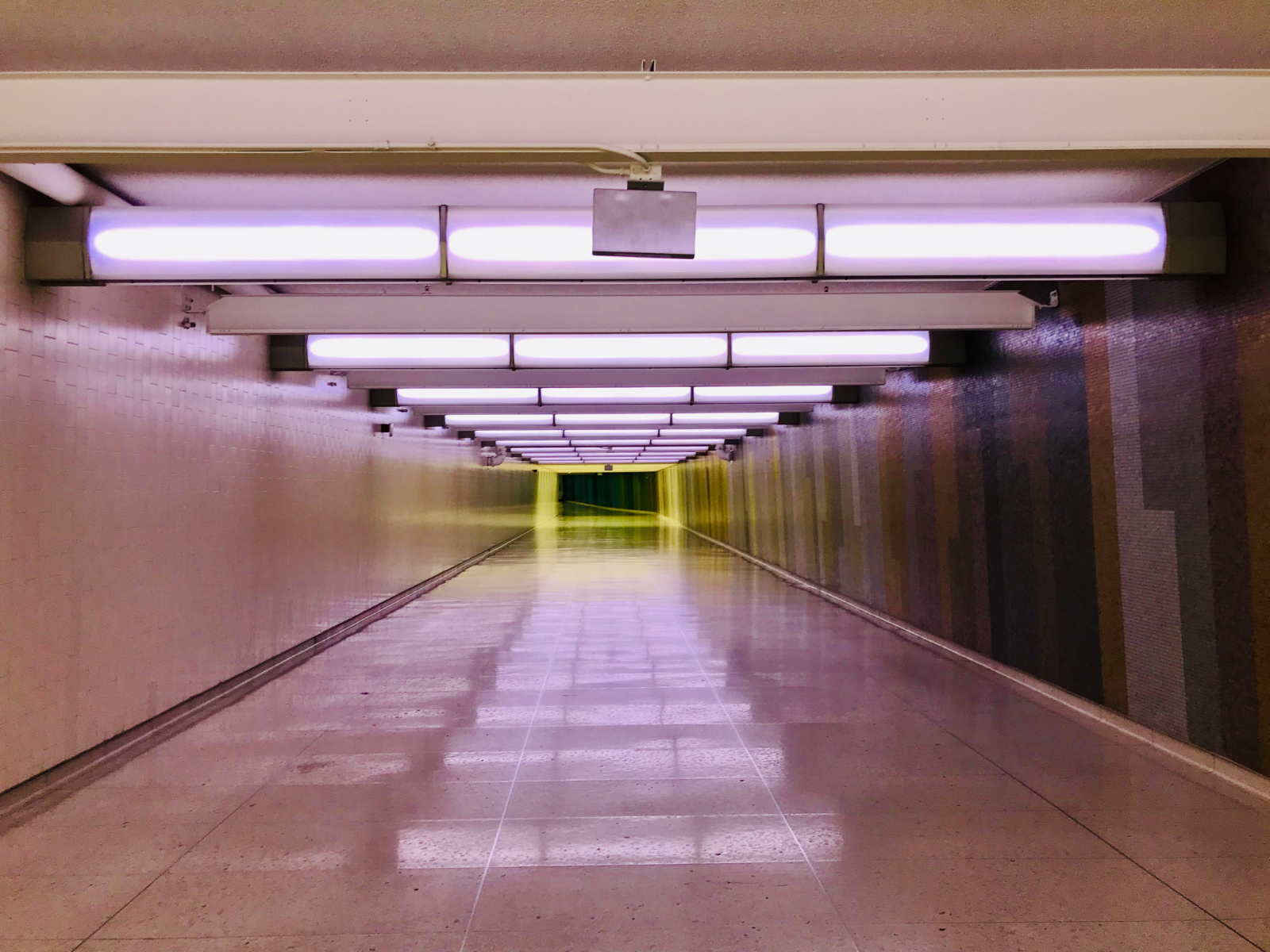 photo of an empty and eerily lit airport corridor